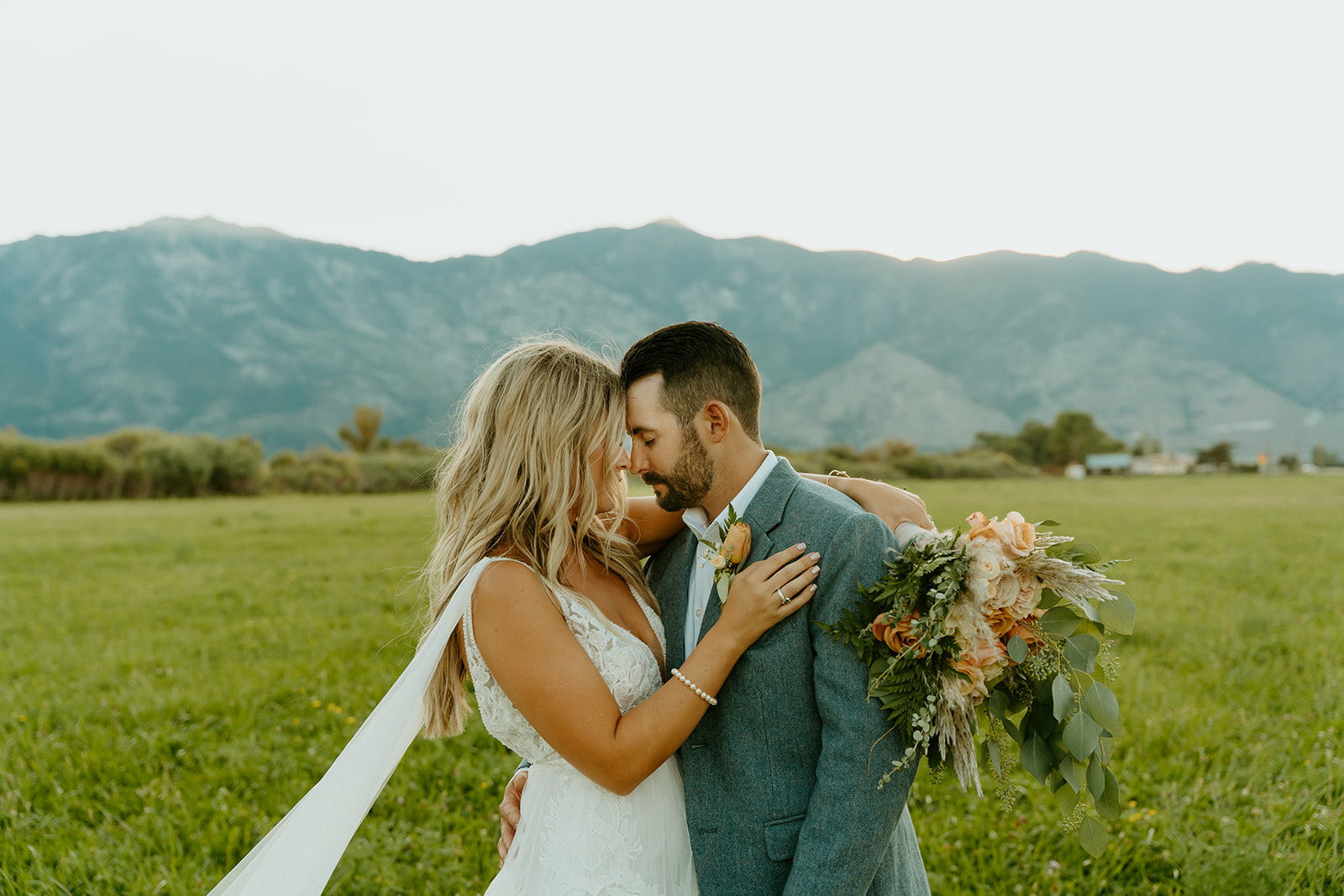 Reno wedding photographer captures bride and groom embracing and touching foreheads after western wedding
