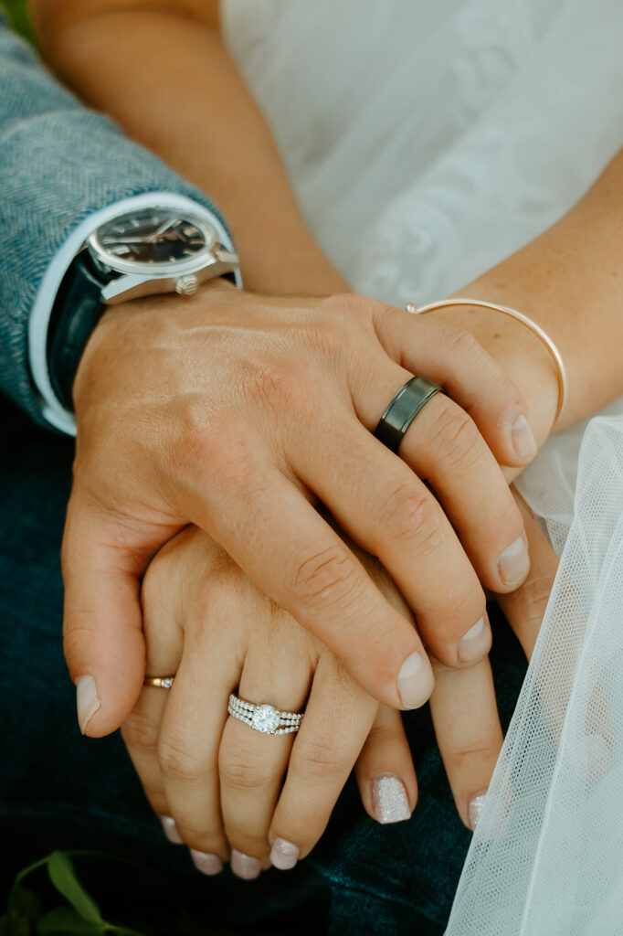 Reno wedding photographer captures bride and groom holding hands showing new wedding rings