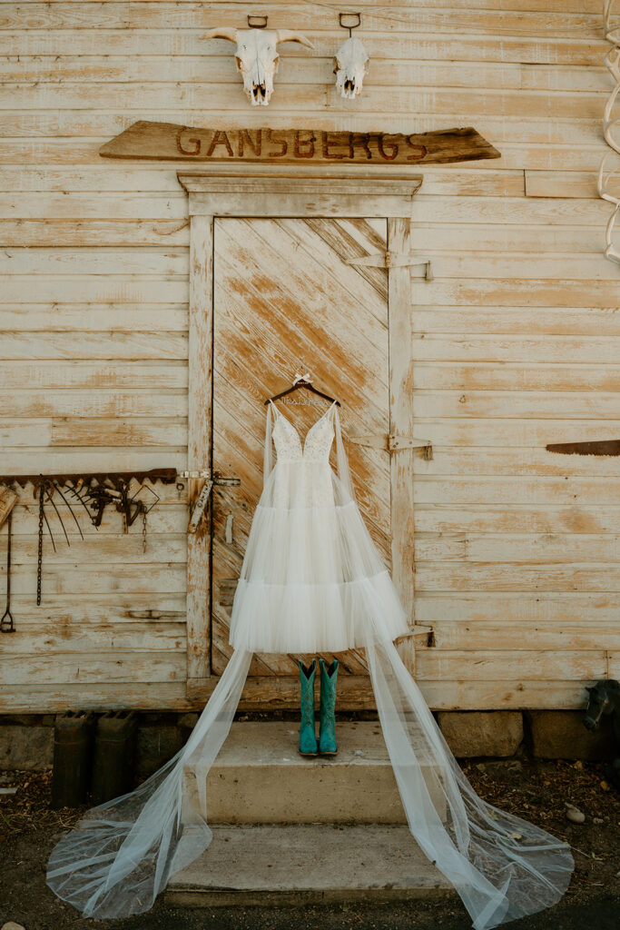 Reno wedding photographer captures wedding dress hanging from barn before western wedding