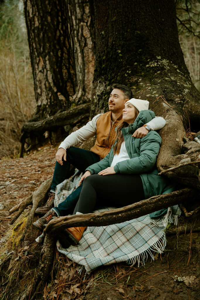 Yosemite wedding photographer captures couple sitting on picnic blanket in Yosemite National Park
