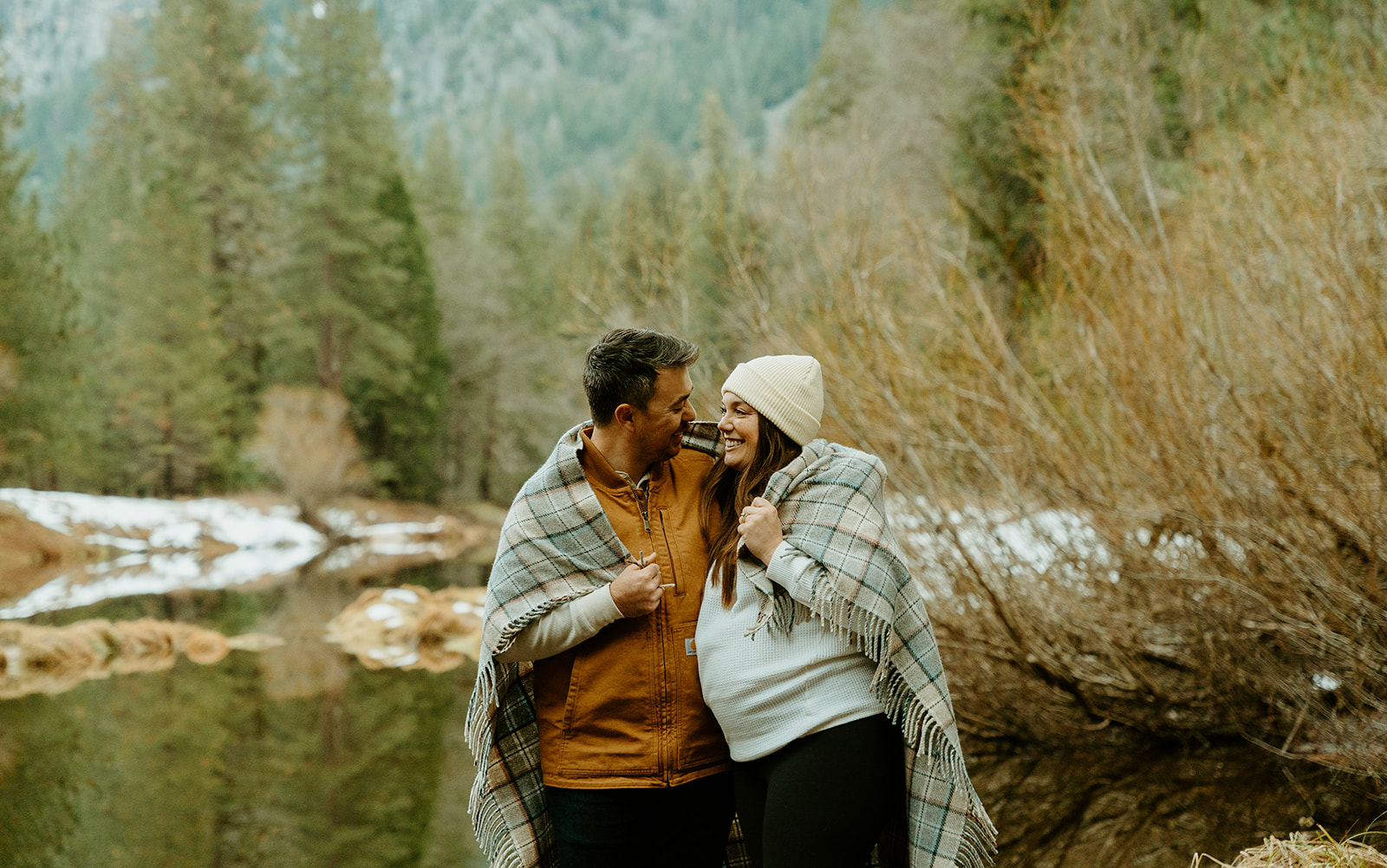 Yosemite wedding photographer captures couple cuddling under blanket in Yosemite park