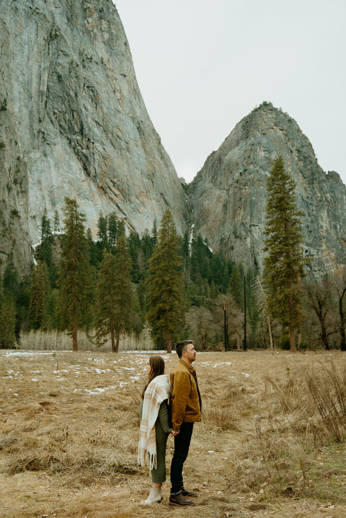 Yosemite wedding photographer captures couple standing back to back in Yosemite National Park during maternity photos