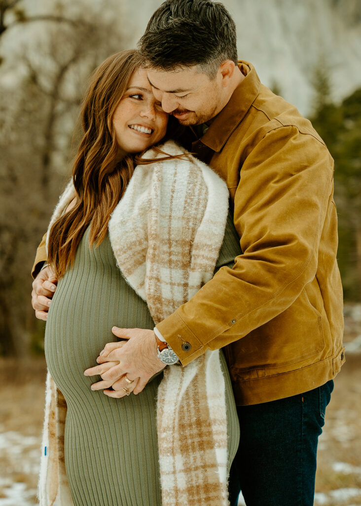 Yosemite wedding photographer captures husband holding wife's pregnant belly during Yosemite maternity photos