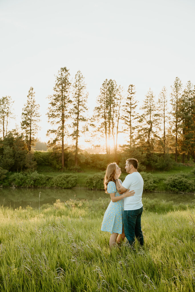 Reno wedding photographer captures man and woman slow dancing in field during spring engagement photos