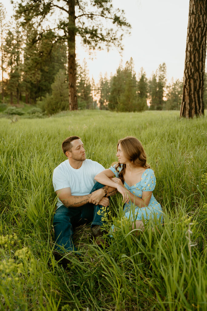 Reno wedding photographer captures man and woman sitting in grass together 
