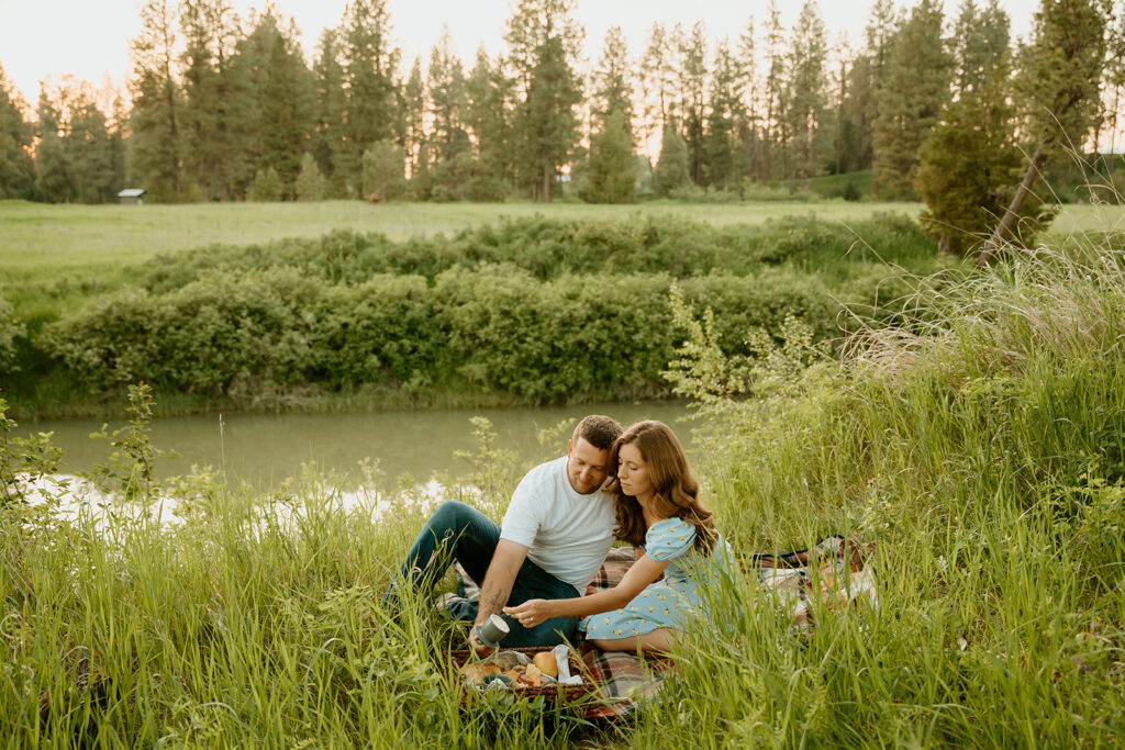 Reno wedding photographer captures man and woman sitting on picnic blanket during engagement photos