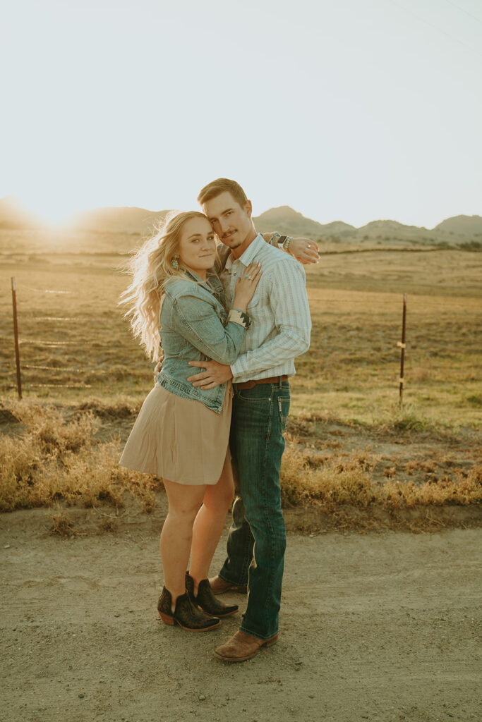 Reno wedding photographer captures newly engaged couple embracing at golden hour