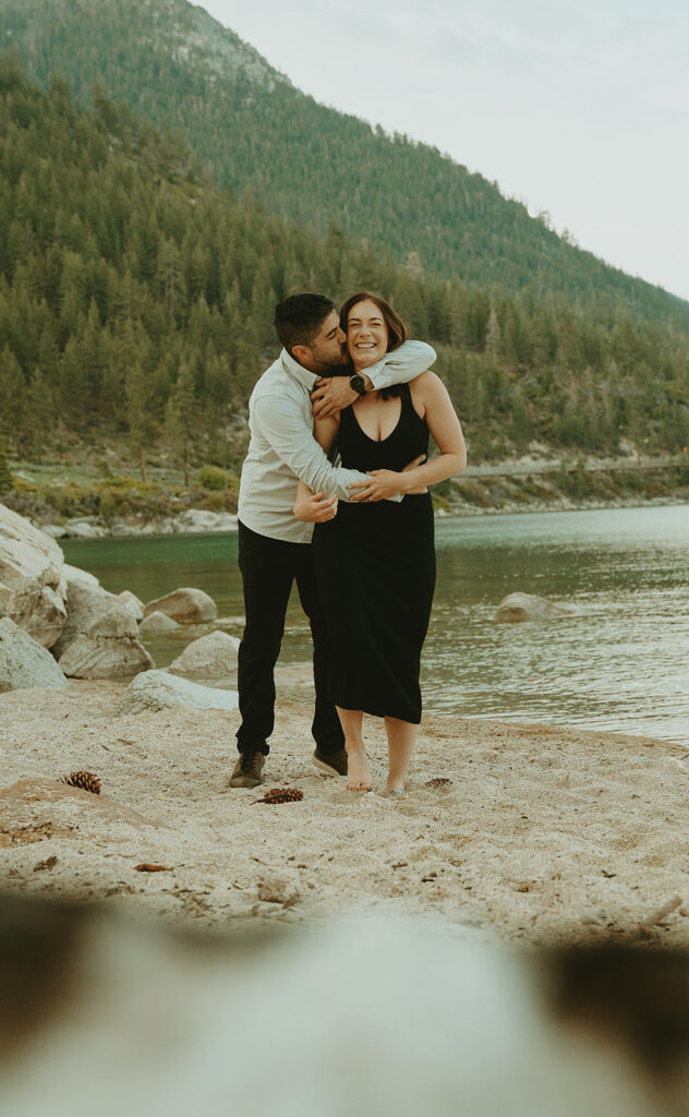Reno wedding photographer captures man hugging woman from behind during spring engagement photos
