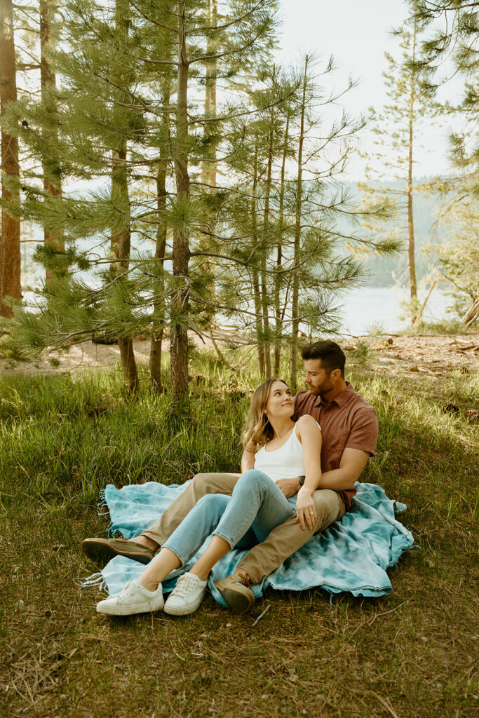 Reno wedding photographer captures engaged couple sitting on picnic blanket