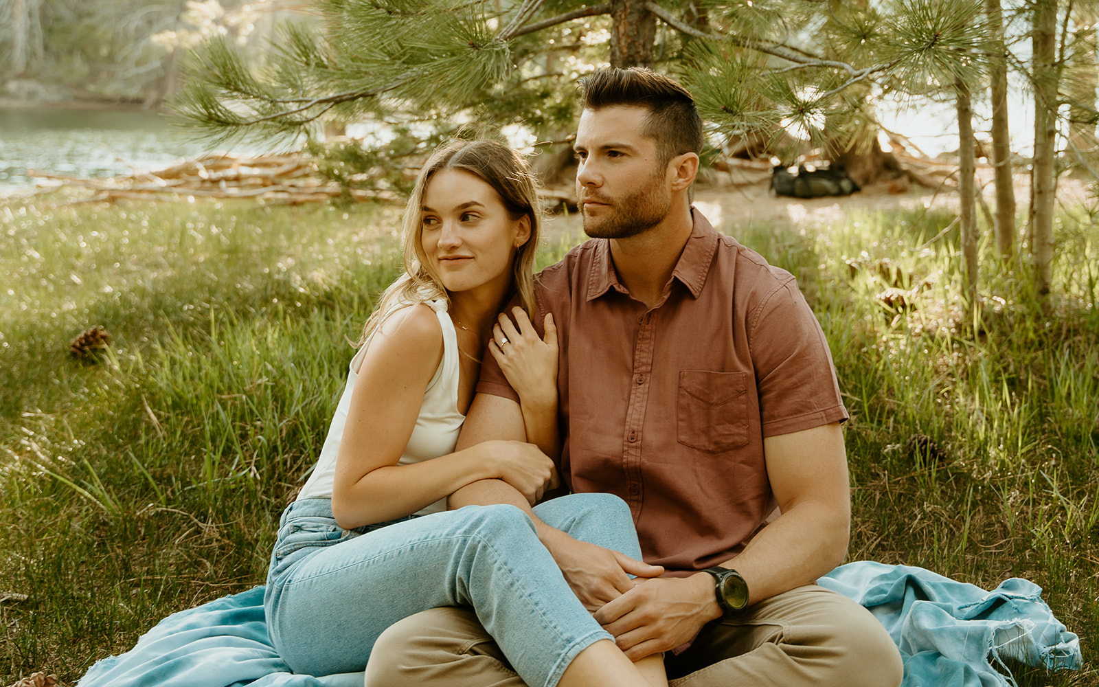Reno wedding photographer captures couple sitting together on picnic blanket during spring engagement photos