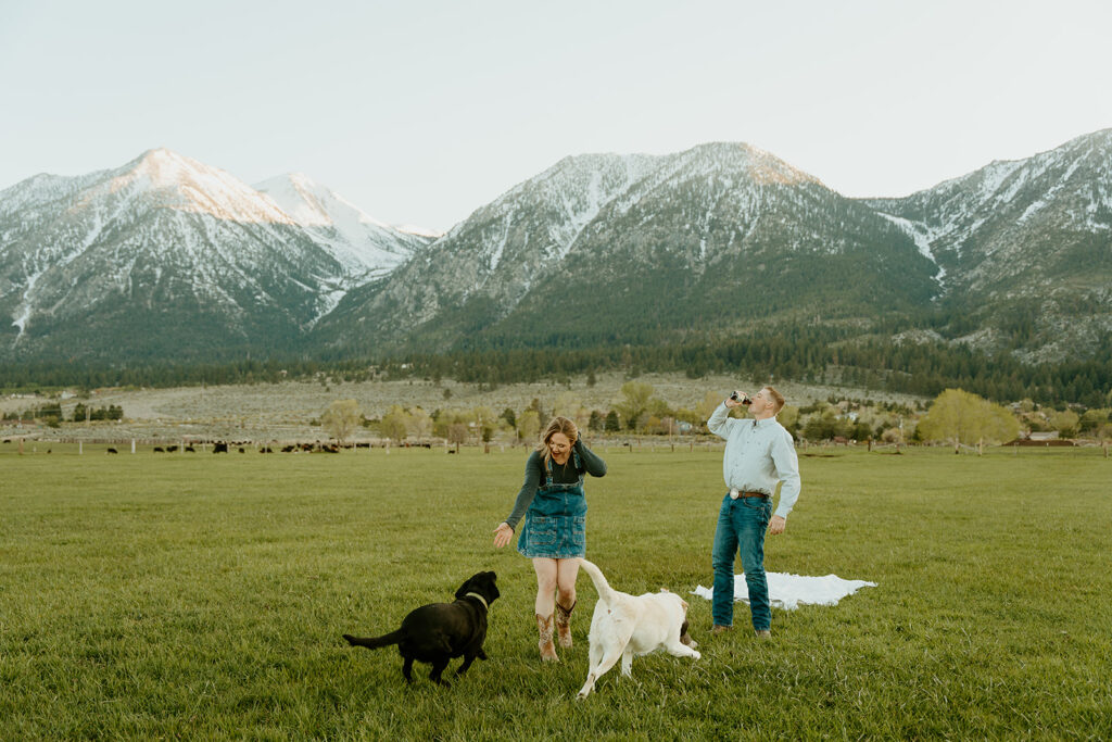 Reno wedding photographer captures man and woman walking with dogs during adventure couples photoshoot