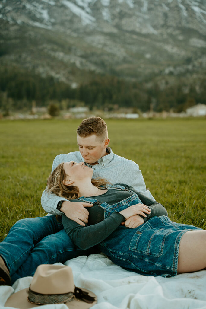 Reno Wedding Photographer captures newly engaged couple sitting on blanket