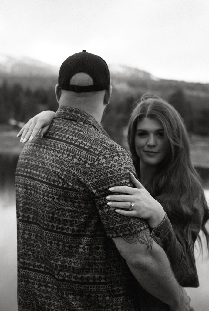 Reno wedding photographer captures woman hugging fiance while looking at camera