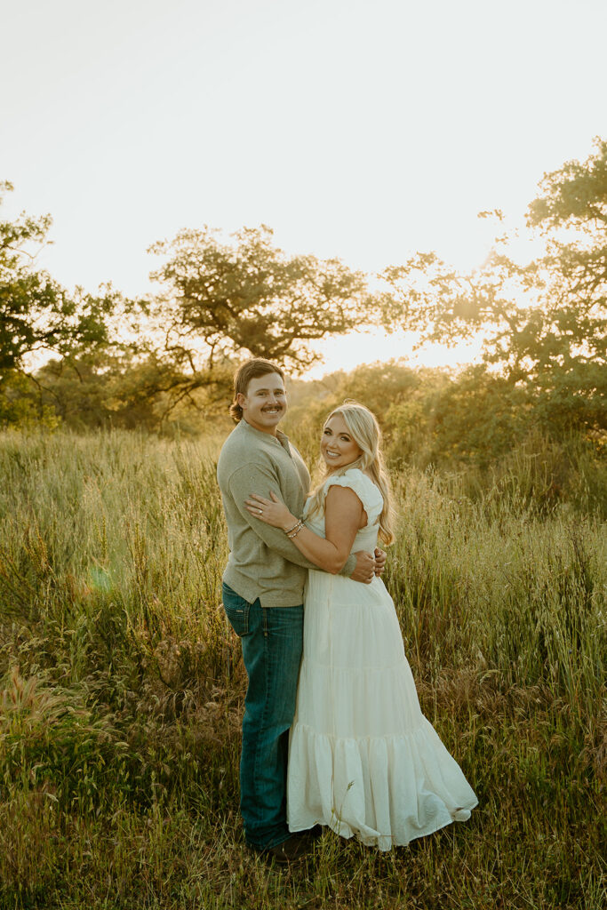 Reno wedding photographer captures couple embracing during golden hour summer engagement photos