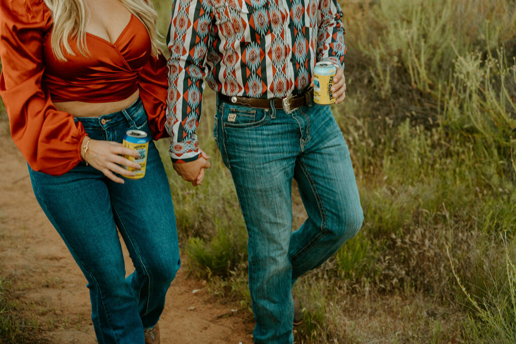 Reno wedding photographer captures couple walking hand in hand holding beers