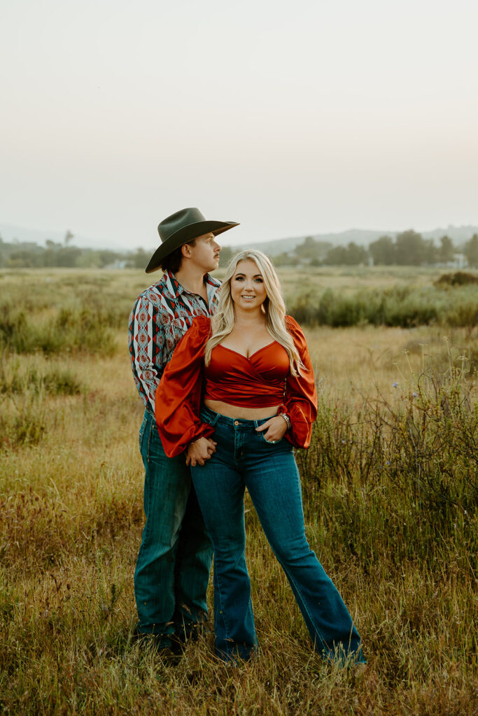 Reno wedding photographer captures woman wearing red shirt standing in front of fiance wearing a patterned shirt