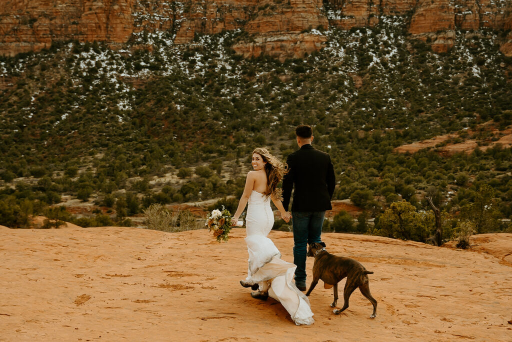 Wedding Photographers Reno capture bride and groom walking away on top of mountain