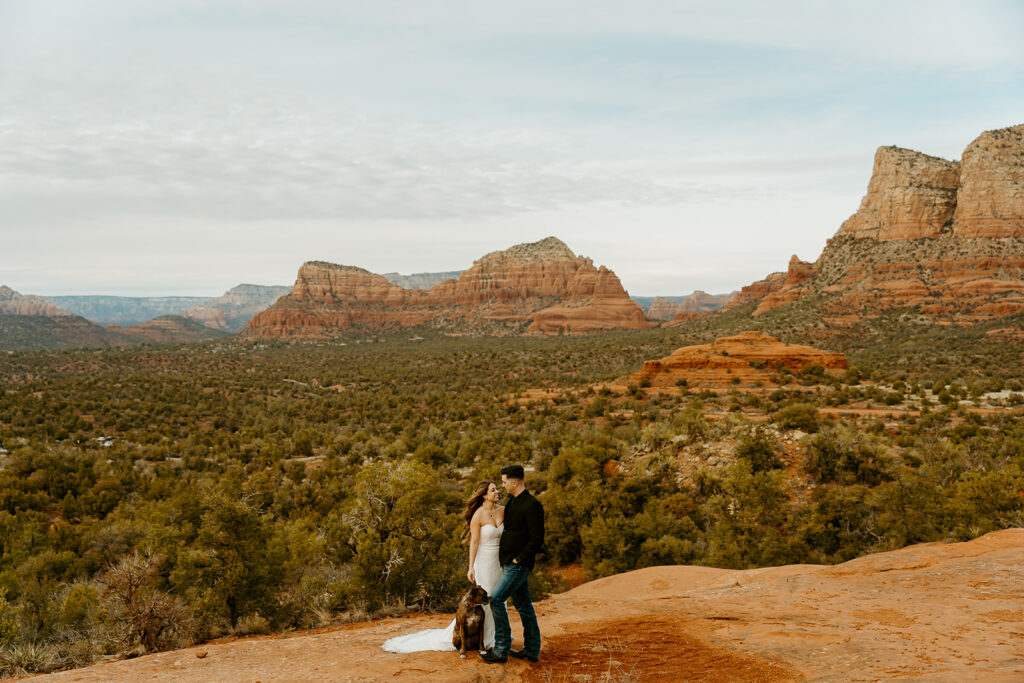 Wedding Photographer Reno captures bride and groom kissing in red rocks during intimate wedding portraits