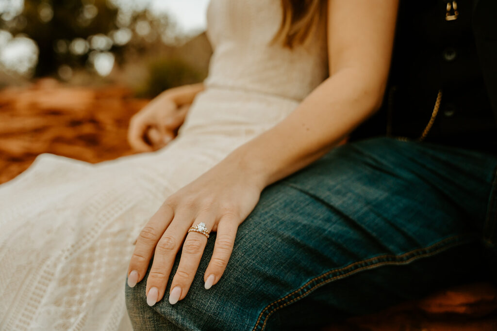 Wedding Photographers Reno captures bride's hand on groom's knee showing engagement ring