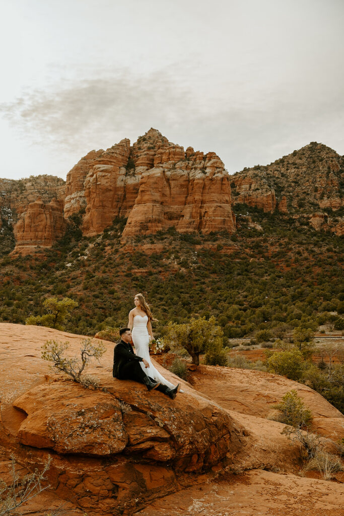 Reno Wedding Photographer captures bride and groom on red rocks after wedding day hike