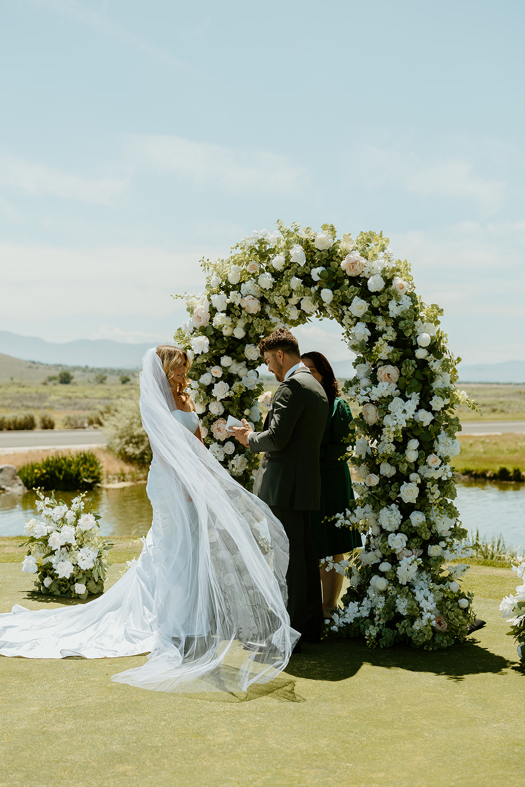 Reno Wedding Photographer captures bride and groom holding hands at alter