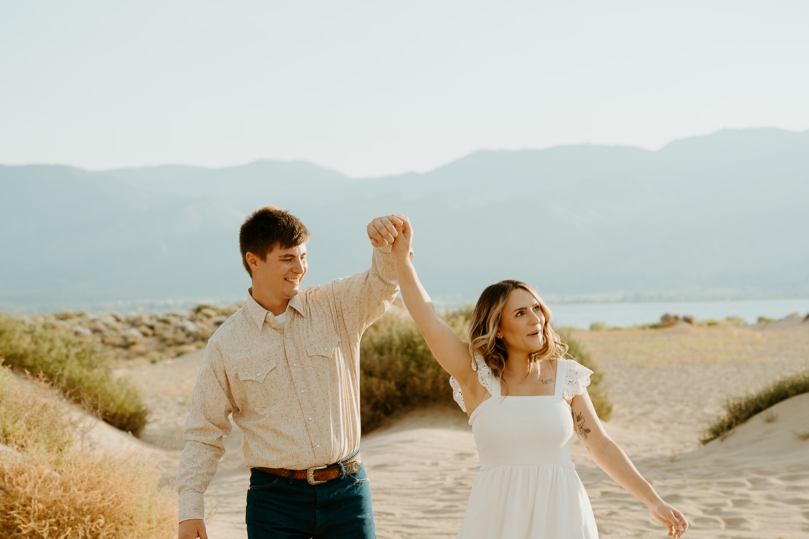 Reno Wedding Photographer captures couple holding hands in the air