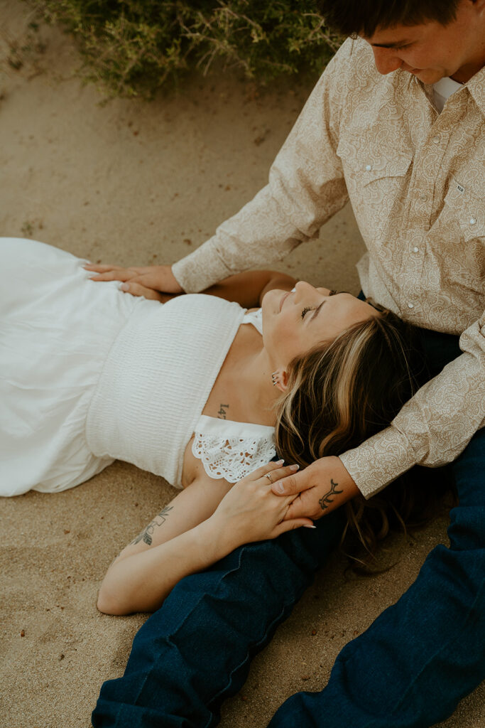 Reno Wedding Photographer captures woman laying in man's lap during outdoor engagements