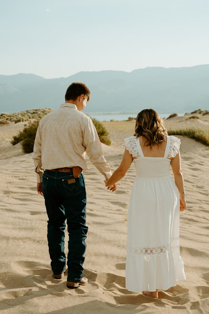 Reno Wedding Photographer captures man and woman walking hand in hand after engagement